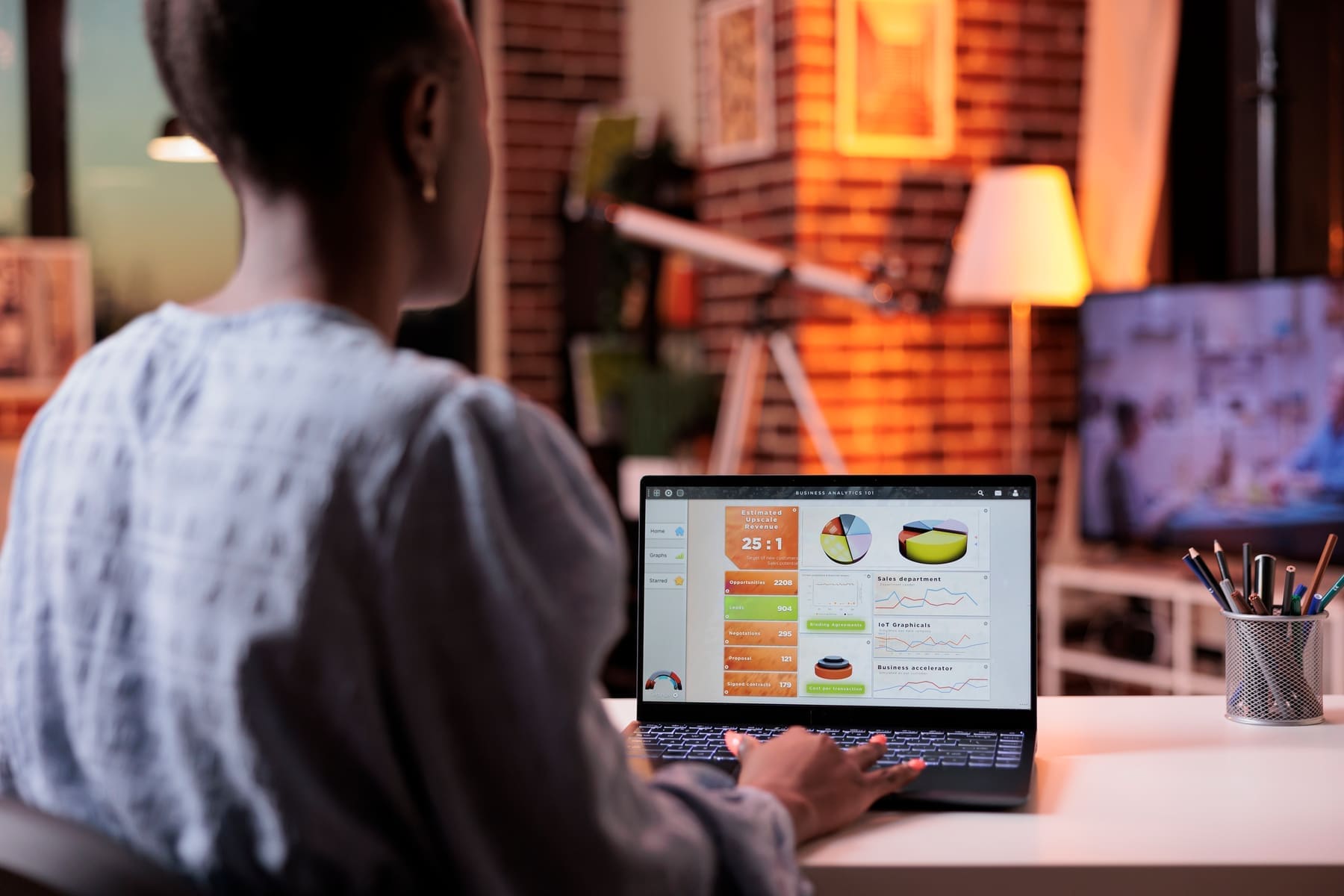 Store owner reviewing online sales and revenue analytics on a laptop